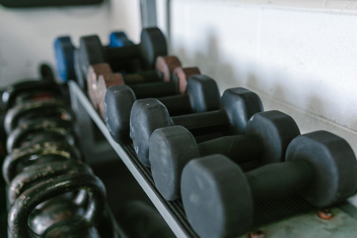 Adjustable dumbbells and a kettlebell in a home gym